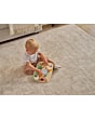 3333151131_2026_TinyLove_WoodenBusyBoard_FarmersFunday_Lifestyleimage_littleboysittedoncarpet